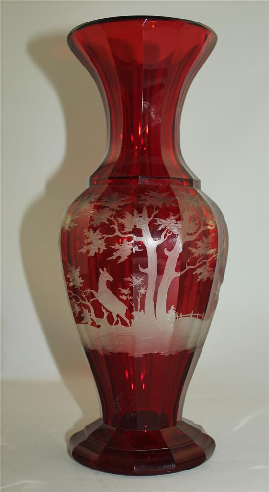A Bohemian ruby glass multi-facetted baluster vase, late 19th century, 31.5cm